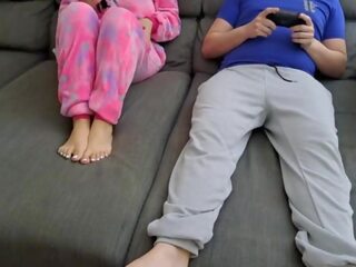 Stepsister sucks stepbrother and eats his sperm while he plays video games