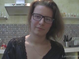 Solo girl with glasses chatting in the kitchen